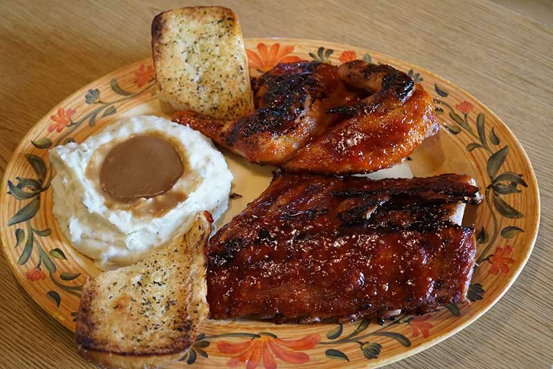 Ribs, grilled chicken, and garlic bread with mashed potatoes